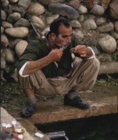 Colonel Akrawi shaving, Iraqi Kurdistan, June 1965